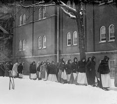 Patients at the Chicago State Hospital walking outdoors on a snow-covered path, Chicago, Illinois, December 10, 1910. The Chicago State Hospital (also called the Dunning Mental Institute) was located at West Irving Park Road and North Narragansett Avenue in the Dunning neighborhood